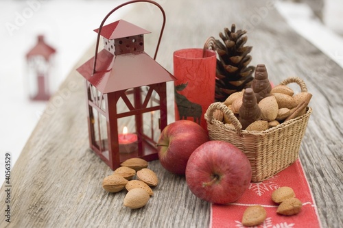 Photo: Christmas decoration with apples, nuts & lantern on table Christmas decoration with apples, nuts & lantern on table