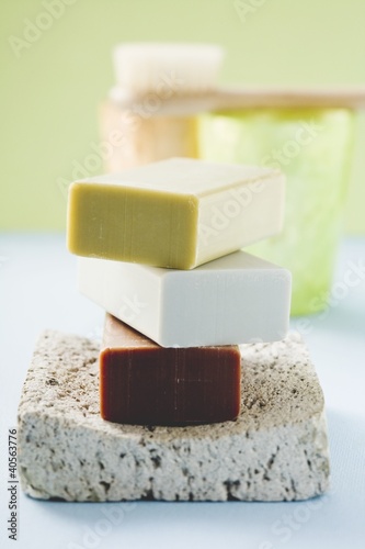 Foto: Three bars of soap on pumice stone, windlights, brush Three bars of soap on pumice stone, windlights, brush