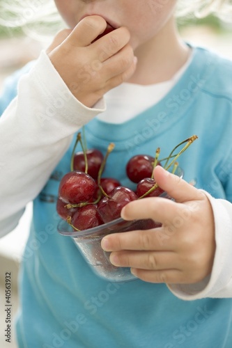 Photo: Child eating fresh cherries Child eating fresh cherries