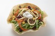 Tortilla shell with mince and bean filling and sour cream