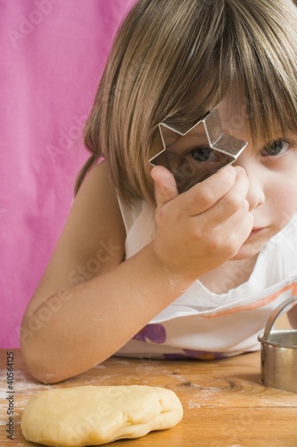 Photo: Child peeping through a biscuit cutter Child peeping through a biscuit cutter