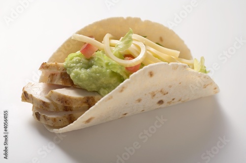 Photo: Folded tortilla filled with chicken, guacamole and cheese Folded tortilla filled with chicken, guacamole and cheese