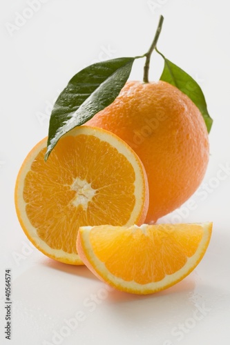 Photo: Orange with stalk and leaf, orange half and wedge Orange with stalk and leaf, orange half and wedge