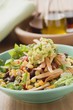 Lettuce, beans, sweetcorn, tortilla strips and guacamole