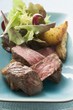 Beef fillet steak with potato wedges and salad