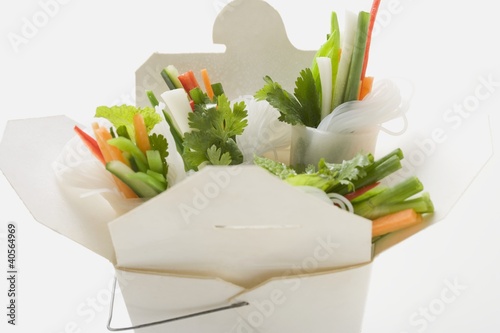 Photo: Rice paper rolls with vegetable filling in take-away container Rice paper rolls with vegetable filling in take-away container