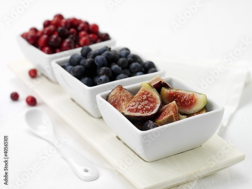 Photo: Fresh figs and berries in dishes Fresh figs and berries in dishes