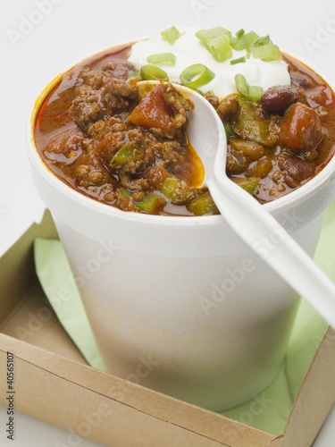 Photo: Chili con carne with sour cream in polystyrene cup (with spoon) Chili con carne with sour cream in polystyrene cup (with spoon)