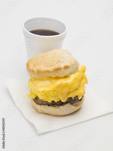 Photo: Scone filled with scrambled egg, cheese & sausage, cup of coffee Scone filled with scrambled egg, cheese & sausage, cup of coffee