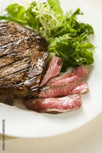 Photo: Partially Sliced Steak; Rare; Side Salad Partially Sliced Steak; Rare; Side Salad