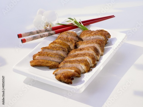 Photo: Sliced duck breast on plate with chopsticks Sliced duck breast on plate with chopsticks