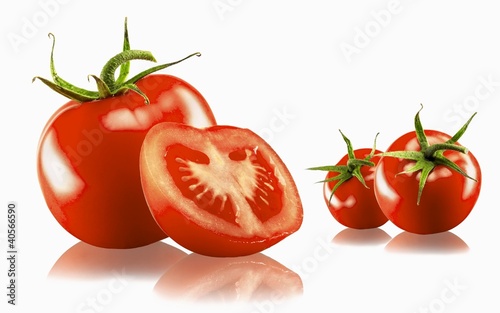 Photo: Three whole and one halved tomato with a white background and reflection Three whole and one halved tomato with a white background and reflection