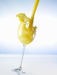 Pouring orange juice into a glass (splash)