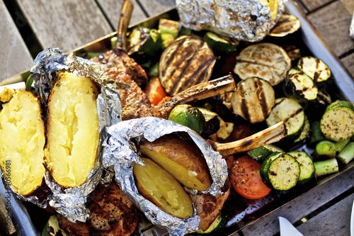 Photo: Barbecued vegetables, baked potatoes, lamb chops on barbecue tray Barbecued vegetables, baked potatoes, lamb chops on barbecue tray