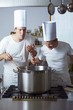 Two chefs standing by range