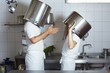 Photo: Two chefs having discussion with large pans on their heads Two chefs having discussion with large pans on their heads