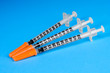 three insulin syringes