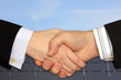 Businessmen shaking hands in front of Solar Power Station