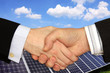 Businessmen shaking hands in front of Solar Power Station