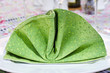 Green Cloth Napkin on a White Plate