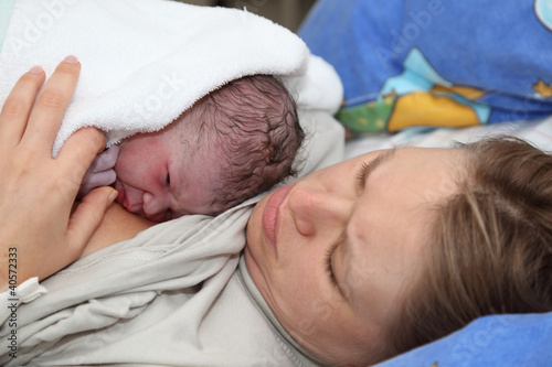Photo: Newborn baby with mother minutes after the birth Newborn baby with mother minutes after the birth
