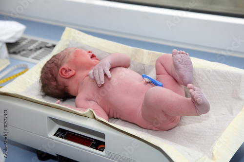 Photo: Newborn baby on the balance Newborn baby on the balance