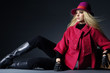 fashion model sitting at black background