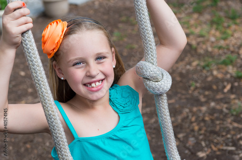 Photo: Girl playing in backyard Girl playing in backyard