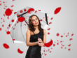 Photo: Pretty woman under umbrella with petals around her Pretty woman under umbrella with petals around her