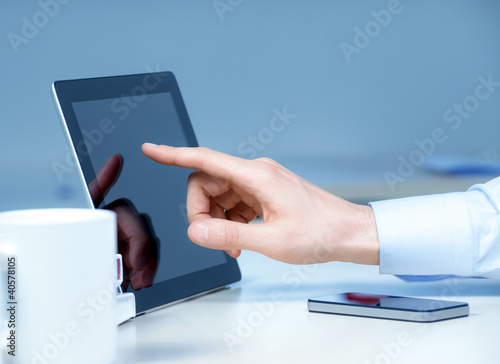 Photo: Businessman Touching On Modern Digital Tablet PC Businessman Touching On Modern Digital Tablet PC