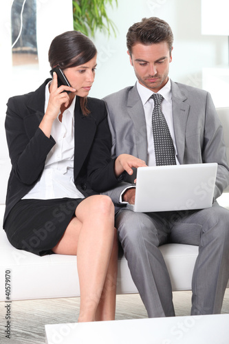 Photo: Couple with phone and laptop Couple with phone and laptop