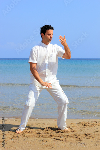 Photo: man on the beach meditating man on the beach meditating