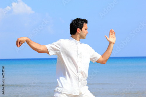 Photo: man on the beach meditating man on the beach meditating