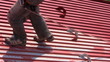 Worker walks on a roof with safety line