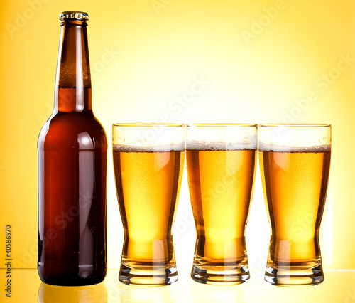 Photo: Three glasses and Bottle of fresh light beer Three glasses and Bottle of fresh light beer