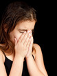 Girl crying and hiding her face
