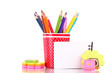 red glass with colorful pencils and stationery isolated on white
