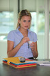 Woman drinking coffee at her desk