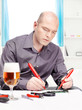 Photo: man repairing an electronic device man repairing an electronic device