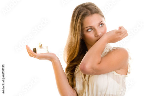 Photo: Woman smelling perfume on wrist Woman smelling perfume on wrist