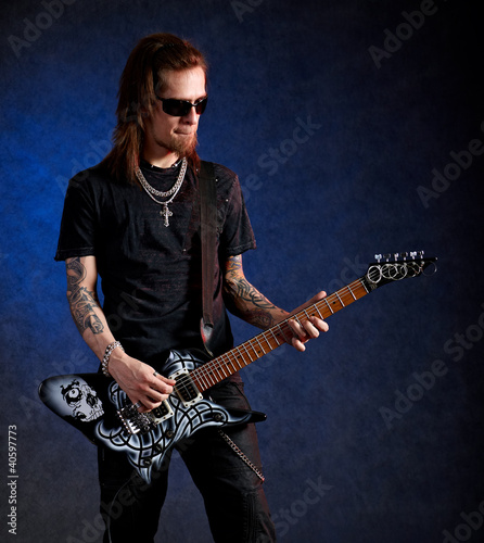 Photo: Brutal man playing electric guitar Brutal man playing electric guitar