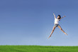 Excited woman jumping over blue sky
