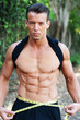 Photo: muscular man measuring waist muscular man measuring waist