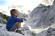 Little boy admiring mountain landscape