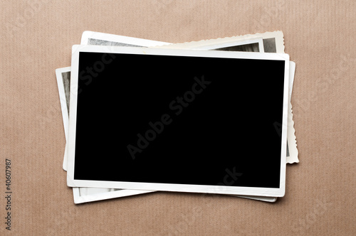 Photo: Stack of old photos on gray cardboard background Stack of old photos on gray cardboard background