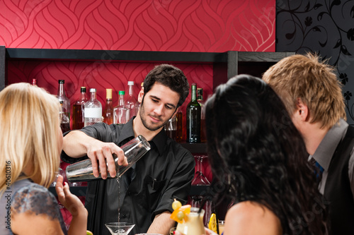 Photo: Barman prepare cocktail friends drinking at bar Barman prepare cocktail friends drinking at bar