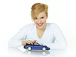 Photo: Pretty girl strokes her dream car on white background Pretty girl strokes her dream car on white background