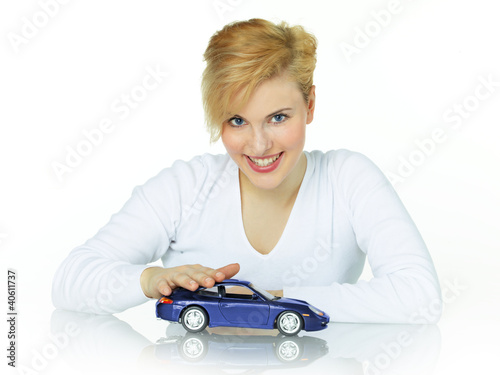 Photo: Pretty girl strokes her dream car on white background Pretty girl strokes her dream car on white background