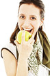 Young beautiful woman with an apple looking towards camera
