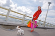 Young shopping woman whit dog ,sea background Young shopping woman whit dog ,sea background